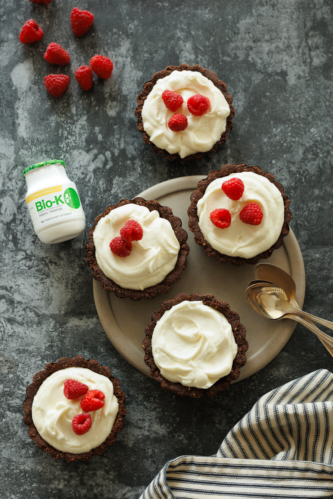 Mini tartlets on a plate with a Bio-K+ bottle