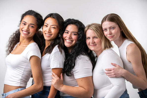 A diverse group of women of different ages smiling, representing vaginal health and wellness for all women.