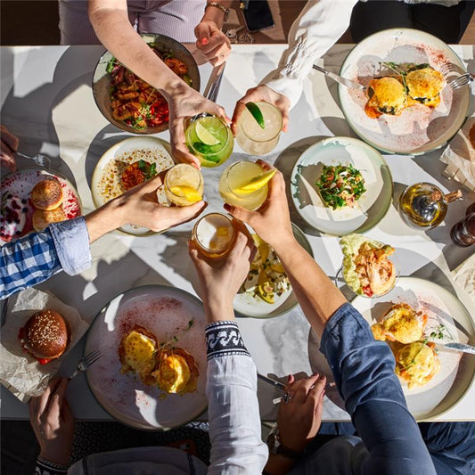 Table full of foods with friends around the table