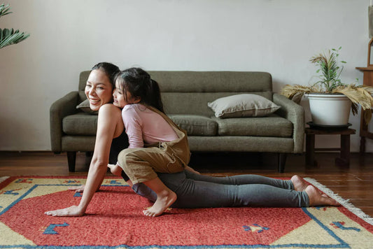Mother and daughter doing yoga together, supporting an active and healthy lifestyle for kids with probiotics.